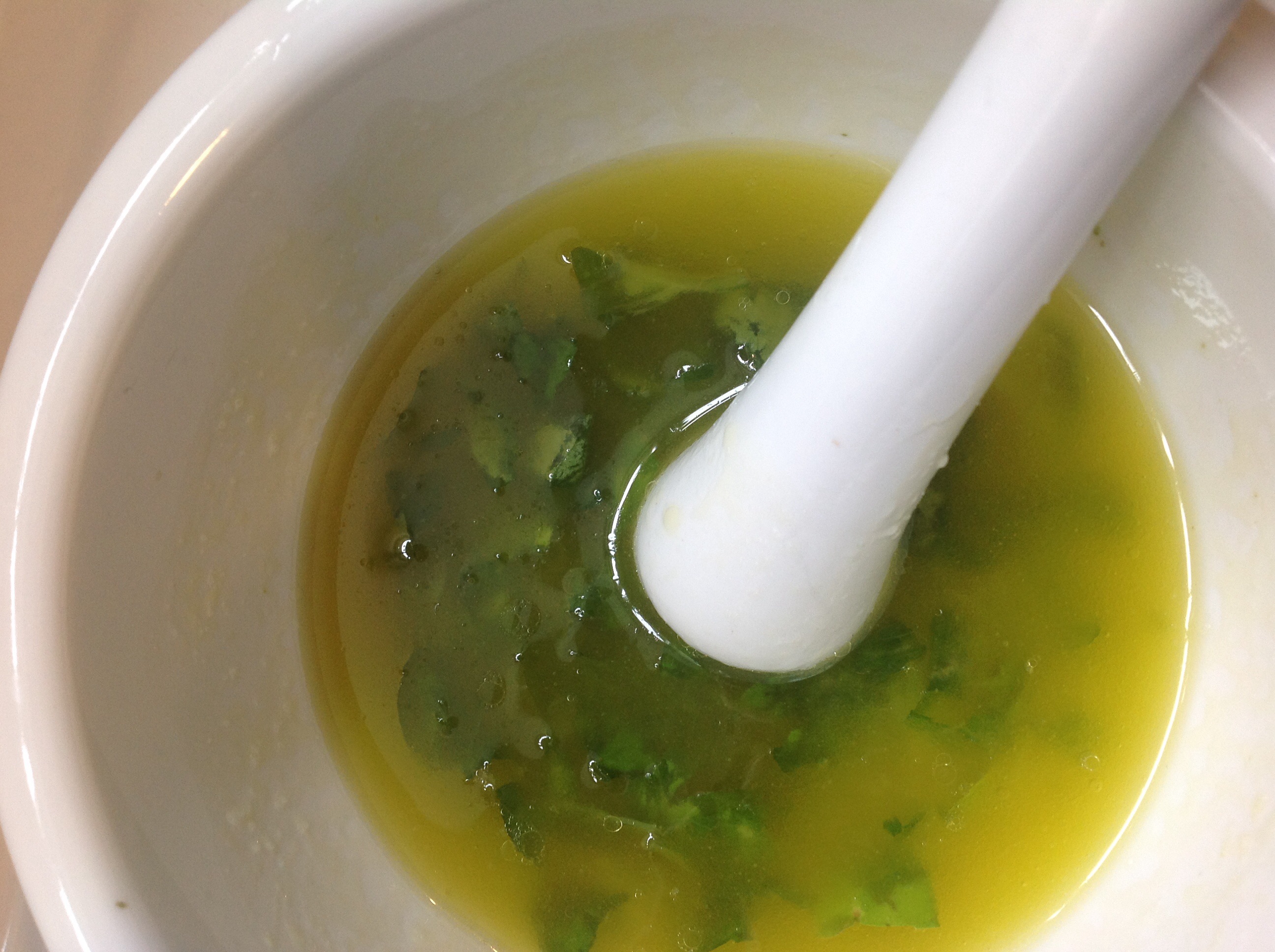 Chopped basil infused in olive oil and lemon